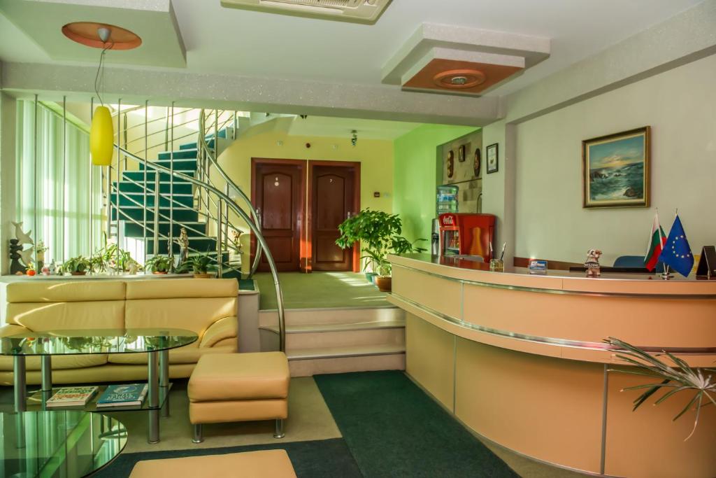 a lobby with a staircase and a waiting room at Hotel Kapri in Yambol