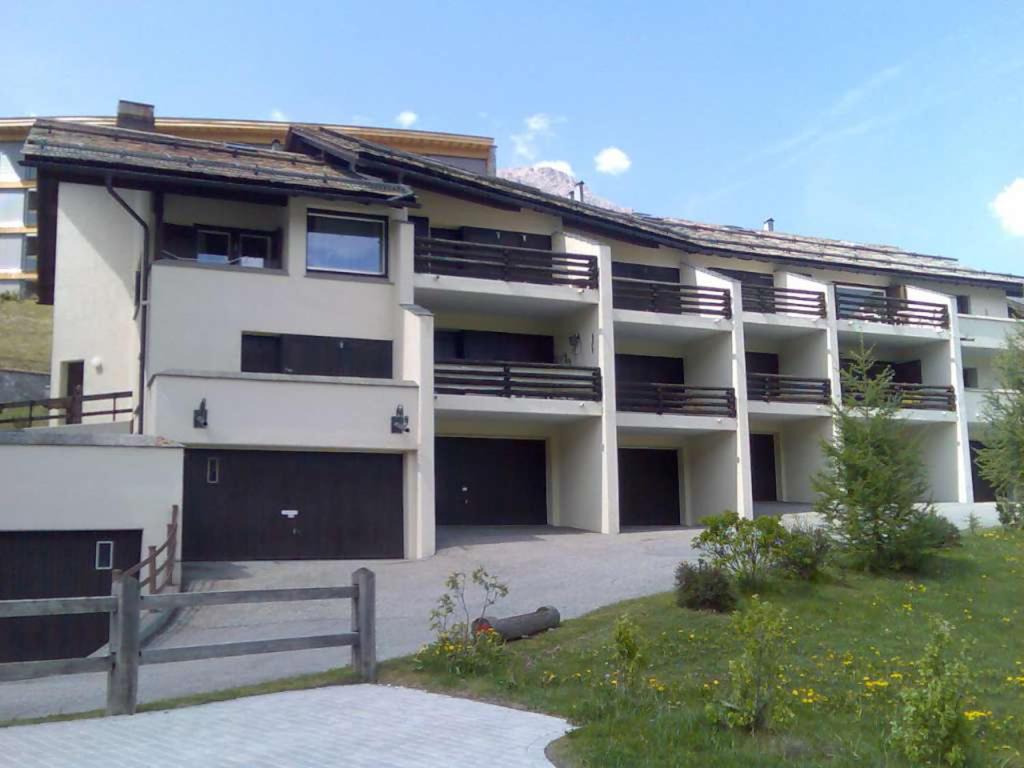 a large white building with a lot of garage at Chesa Panorama in Celerina