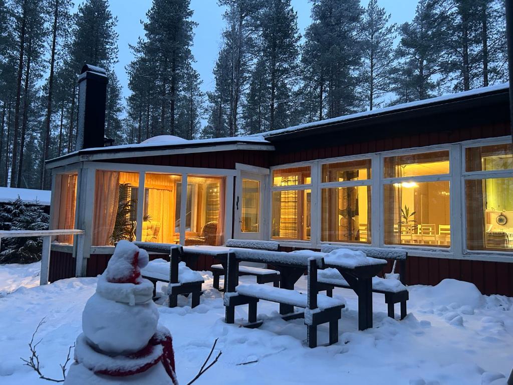 a house in the snow with a lot of windows at Kaamos Old House in Rovaniemi