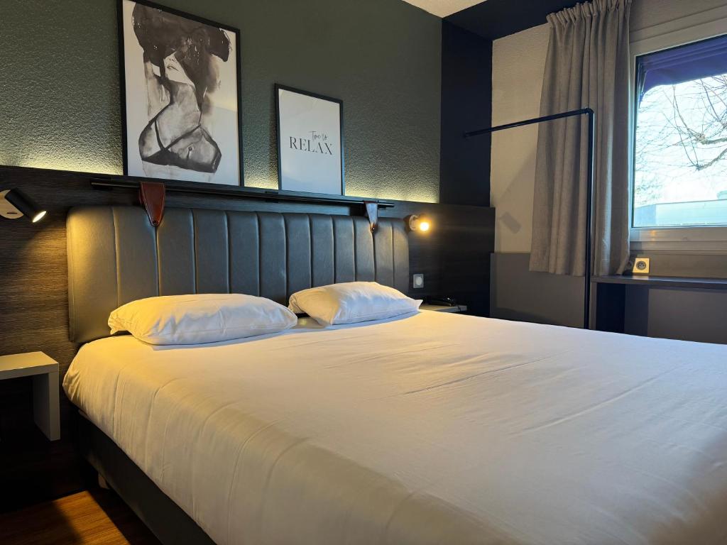 Postel nebo postele na pokoji v ubytování Tulip Inn Beaune