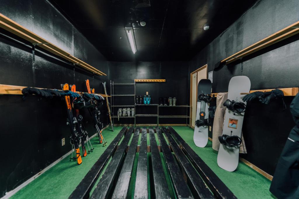 a room with snowboards hanging on the wall at Double Black Hotel in Hakuba