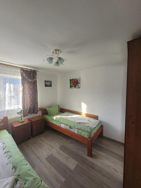 a room with two beds and a window at Mlynski in Mykulychyn