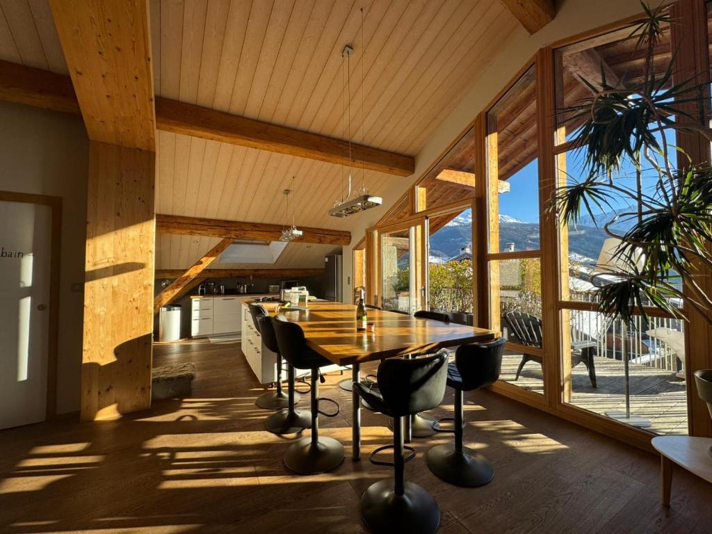 une salle à manger avec une table et des chaises dans une maison dans l'établissement Le nid montagnard - Vulmix, à Bourg-Saint-Maurice