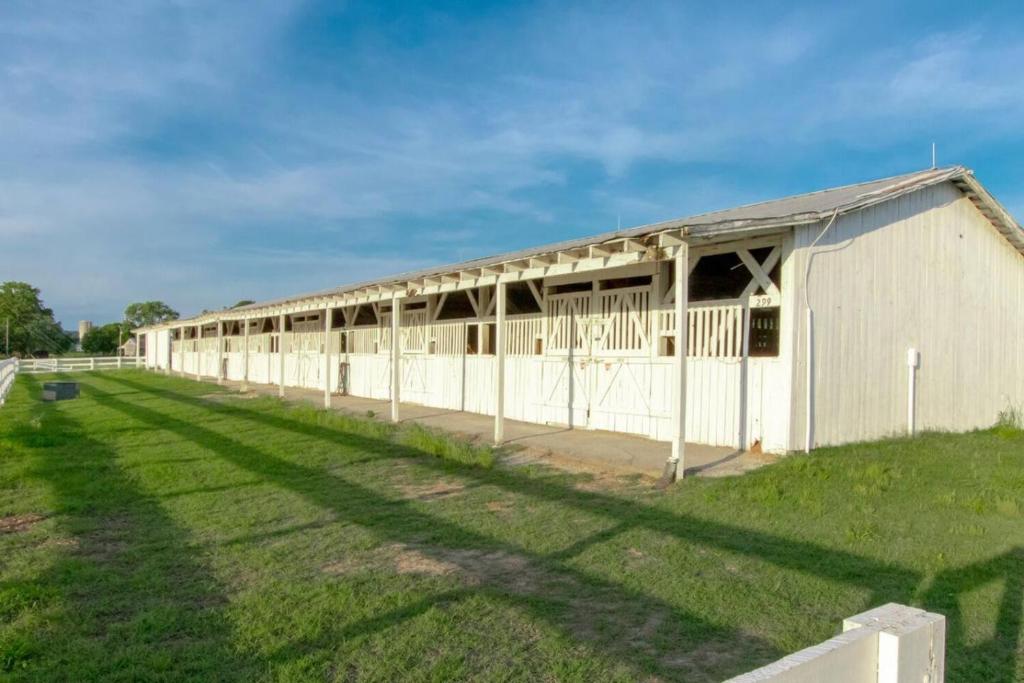 a long white building with a long line of stalls at Charming and Comfortable Historic Franklin Quadplex in Franklin