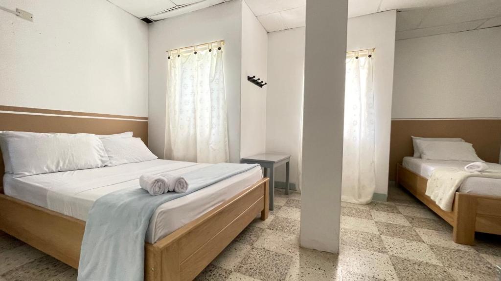 Postel nebo postele na pokoji v ubytování Hotel Balcon de Oro Curumani