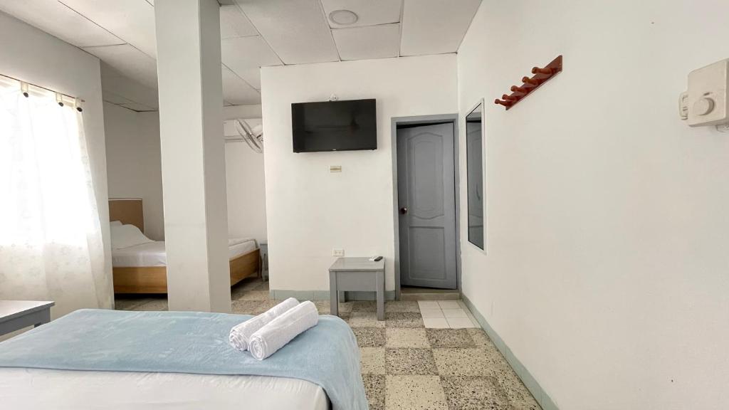 Postel nebo postele na pokoji v ubytování Hotel Balcon de Oro Curumani