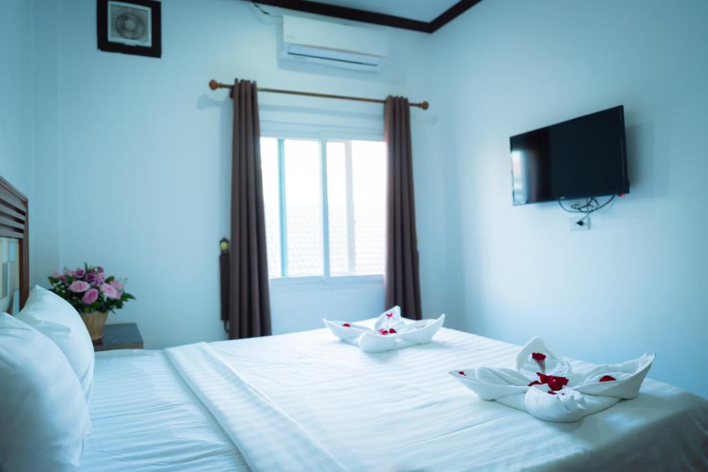 Postel nebo postele na pokoji v ubytování Vientiane Ruby Riverside Hotel
