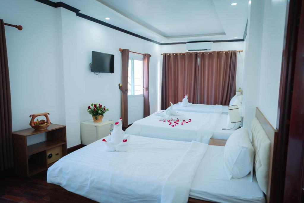 Postel nebo postele na pokoji v ubytování Vientiane Ruby Riverside Hotel