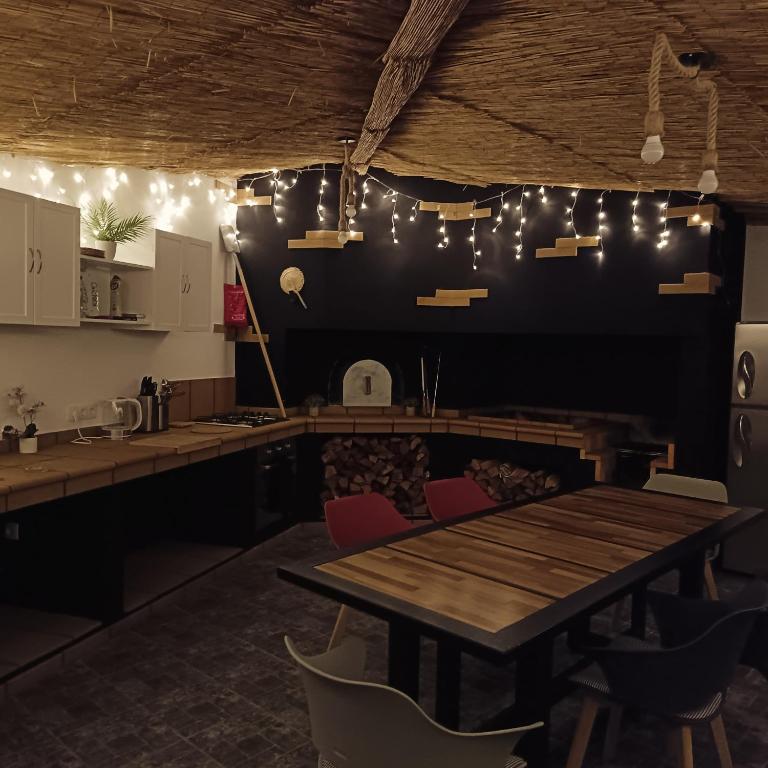 a dining room with a table and chairs and lights at Figueira's House By the Atlantic in Ponta do Sol