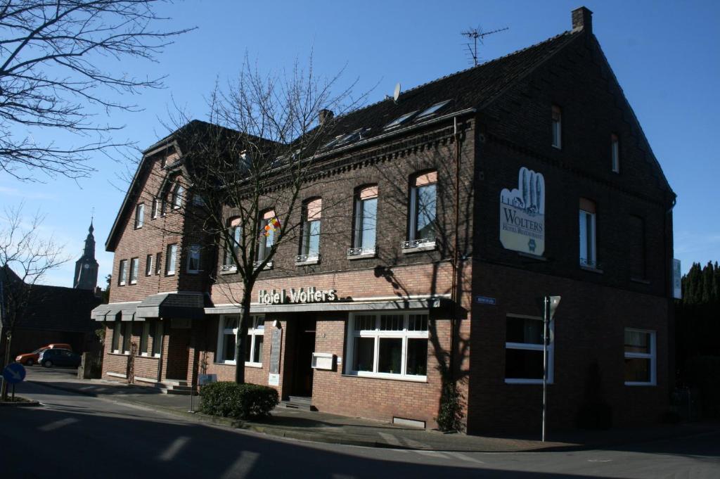 a large brick building on the corner of a street at Landgasthaus Hotel Wolters in Kerken