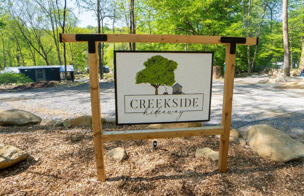 a sign for a park with a tree on it at Tiny home Fire Pit Fishing Pond BBQ Sage Cabin in Gatlinburg