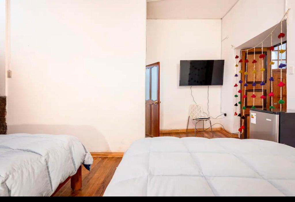 Postel nebo postele na pokoji v ubytování Wasipata Cusco
