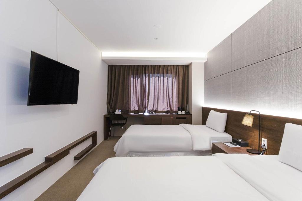 Postel nebo postele na pokoji v ubytování Hotel Elora