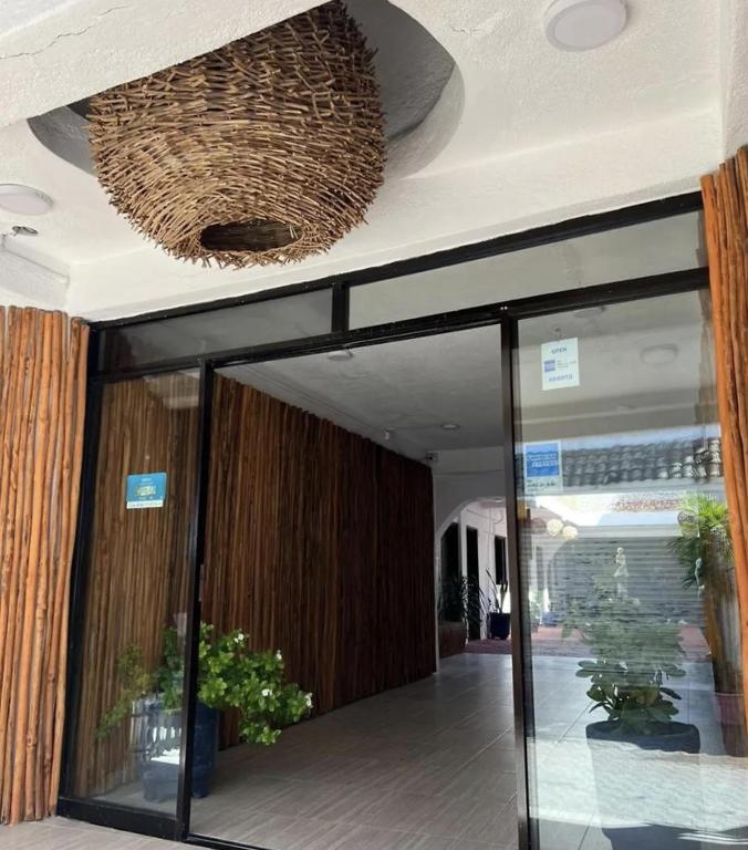 a lobby with a glass door and a ceiling at Hotel Casa Caracol in Isla Mujeres