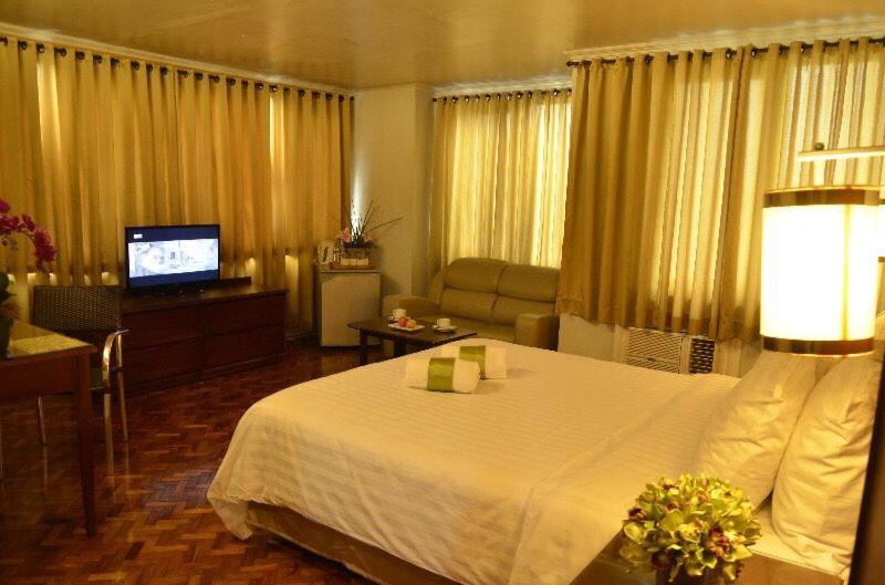 Postel nebo postele na pokoji v ubytování Comfy Inn Manila-Kalaw