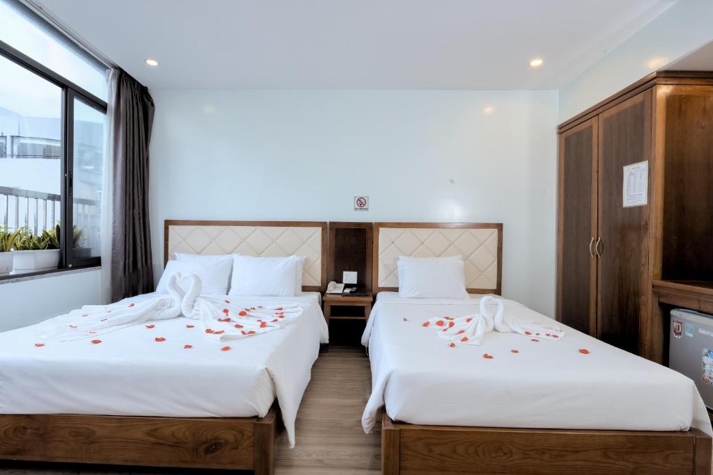 Postel nebo postele na pokoji v ubytování DaNa Sailing Hotel