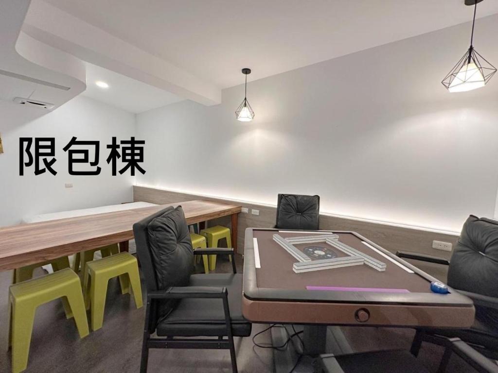 a conference room with a ping pong table and chairs at Kenting Hostel in Kenting
