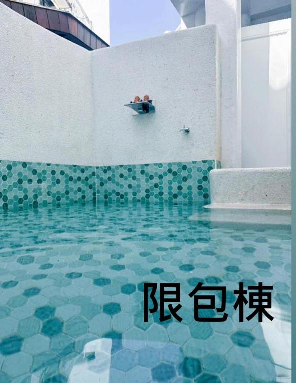 a pool of water with two people sitting in a boat at Kenting Hostel in Kenting