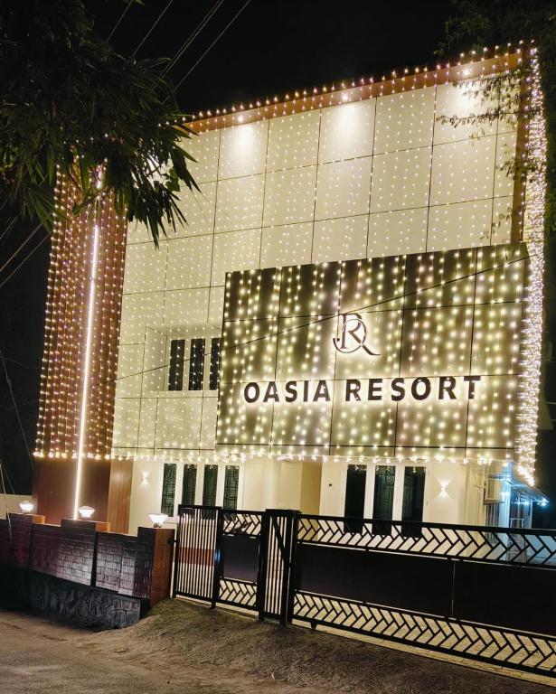 a casa resort lit up at night with lights at Oasia Resort in Kannur