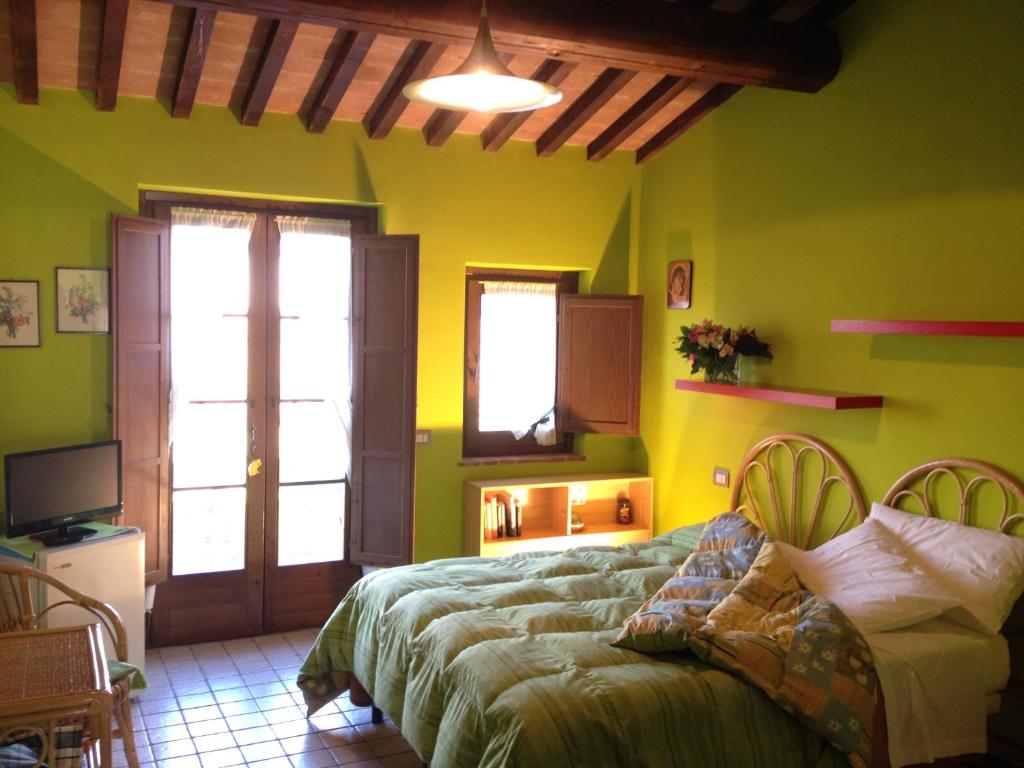 Postel nebo postele na pokoji v ubytování Agriturismo Gattogiallo