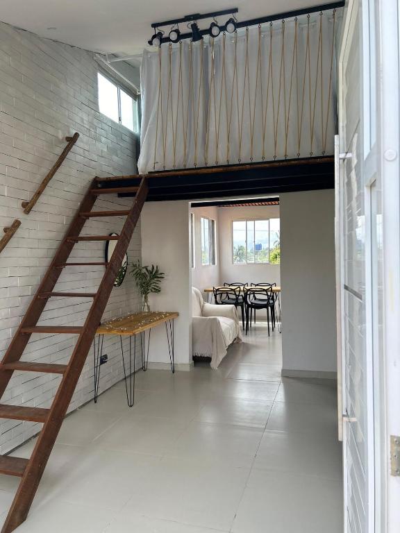 a staircase in a room with a dining room at Apt Maracaipe, Porto de Galinhas in Porto De Galinhas