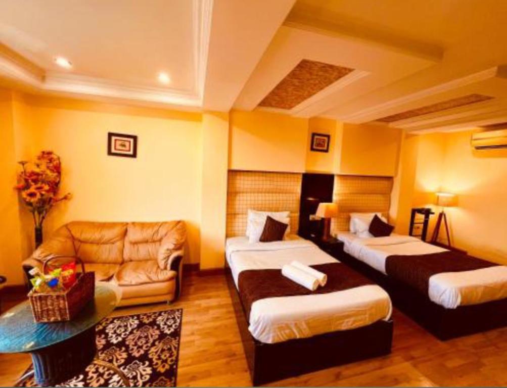 Postel nebo postele na pokoji v ubytování Hotel The Rio, Haridwar