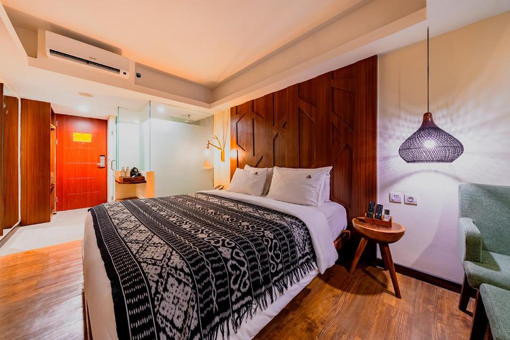 Postel nebo postele na pokoji v ubytování MaxOneHotels at Ubud - CHSE Certified