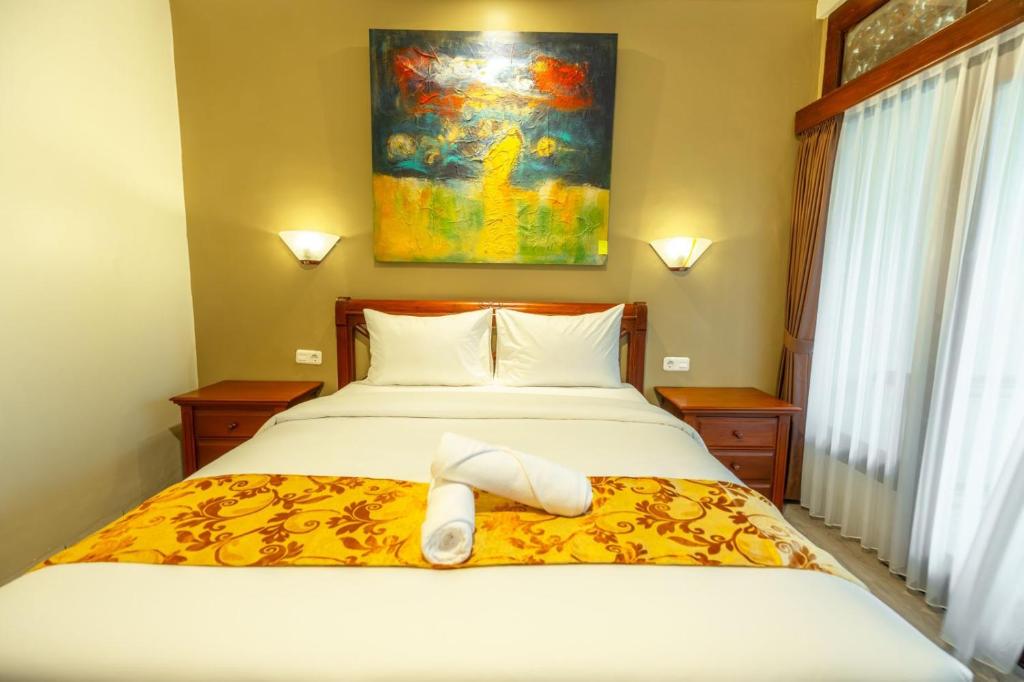 Postel nebo postele na pokoji v ubytování The Central Lovina Hotel & Restaurant