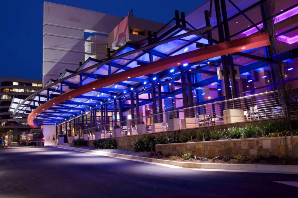 a building with blue and purple lights on it at Wyndham Atlanta Buckhead Hotel & Conference Center in Atlanta
