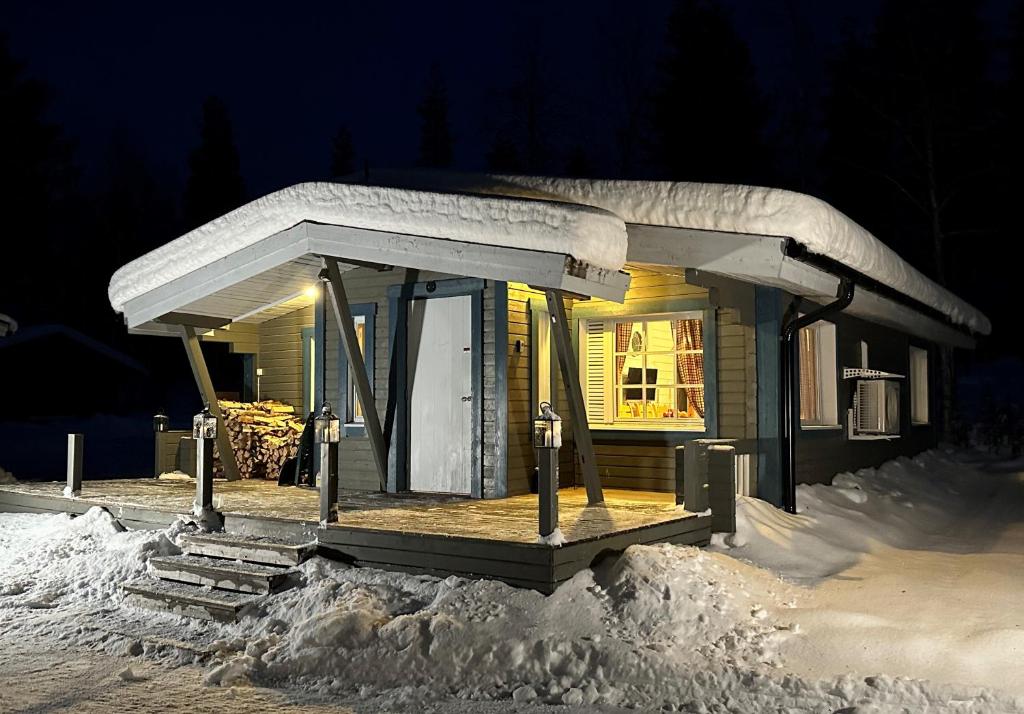 a small house covered in snow at night at Chalet Pellonranta 1 in Pello