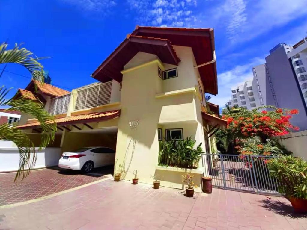a house with a car parked in front of it at 25 guests batu feringhi Miami beach Miami Villa in Batu Ferringhi
