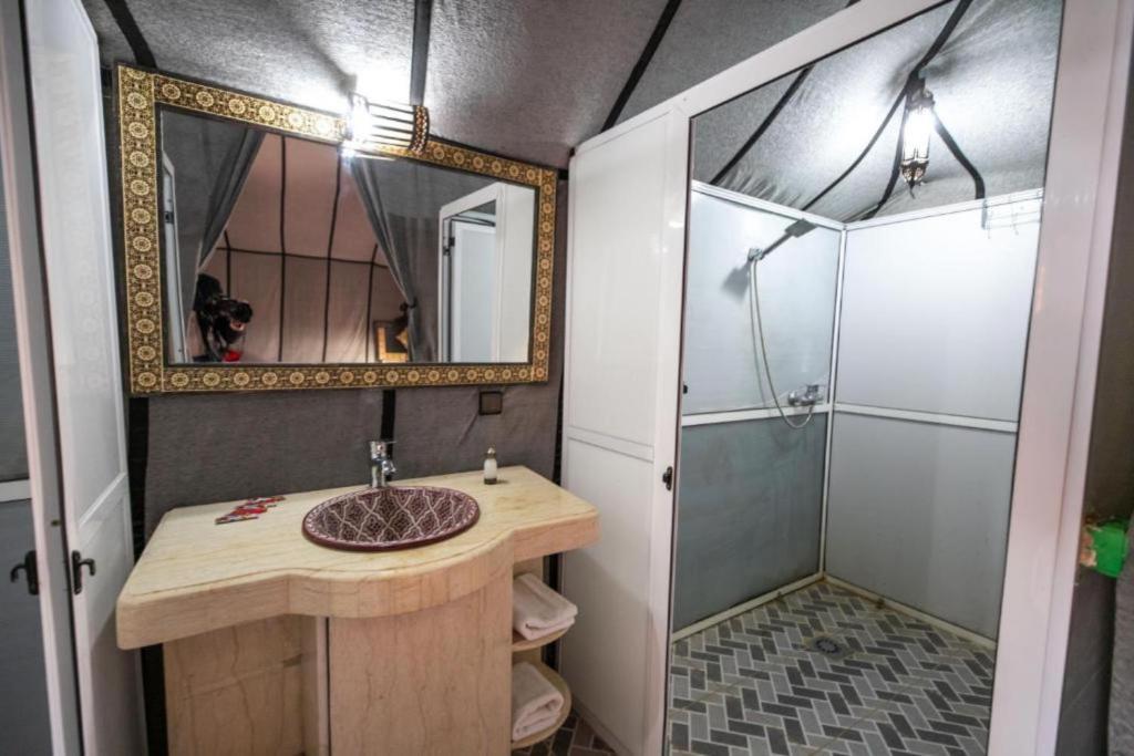 a bathroom with a sink and a shower at Merzouga Desert Campsite &Activities in Merzouga
