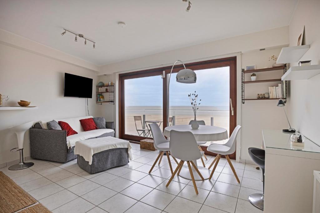 a kitchen and living room with a table and chairs at Atlantis 0102 in Sint-Idesbald