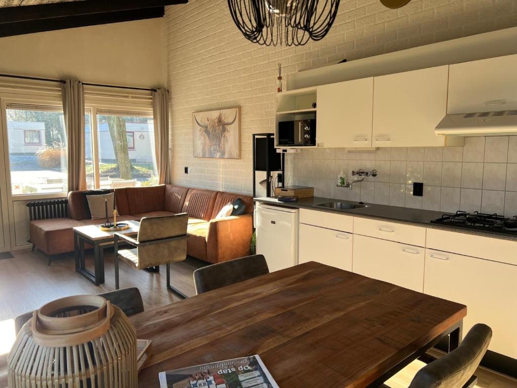 a kitchen and living room with a couch and a table at Huuske14 in Simpelveld