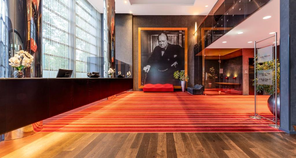 a lobby with a painting of a man on the wall at PLAZA Premium Grand Winston in Rijswijk