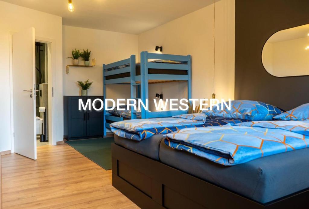 a bedroom with two bunk beds in a room at Modern Western - Apartment Blue in Eging