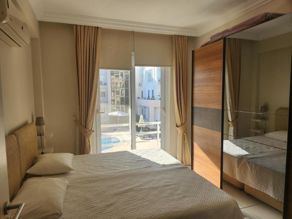 A bed or beds in a room at Antalya belek 4 nirvana club first floor two bedrooms pool view with water slide close to center - belek beach park