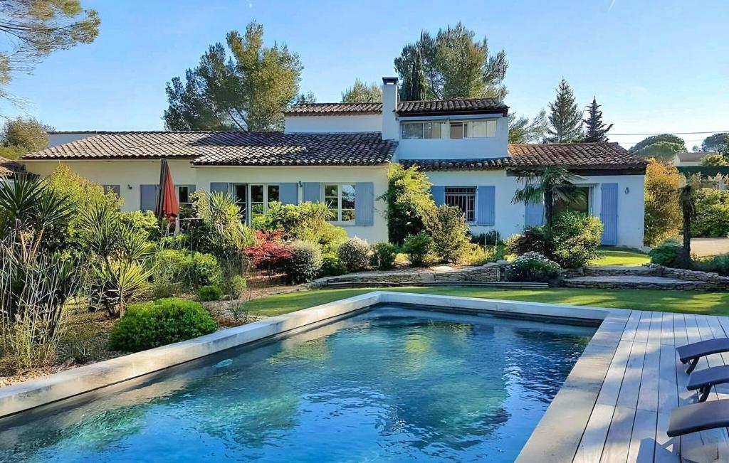 une maison avec une piscine devant une maison dans l'établissement Nice Home In Lisle-Sur-La-Sorgue, à LʼIsle-sur-la-Sorgue