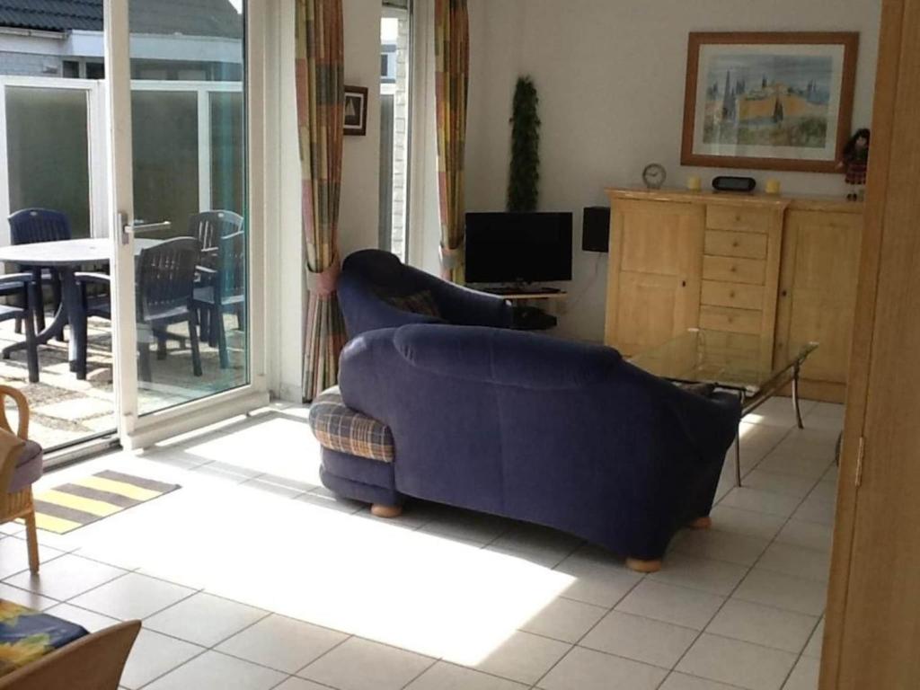 a living room with a couch and a table at bungalow for 6 people, near the beach in Sint Maartenszee