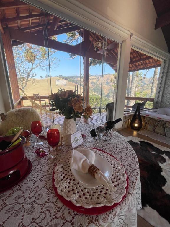 a table with a plate of food on top of it at Chalé Jacarandá in Gonçalves