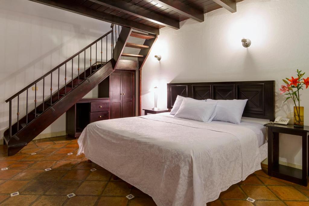 Postel nebo postele na pokoji v ubytování Hotel Casa Real Del Café