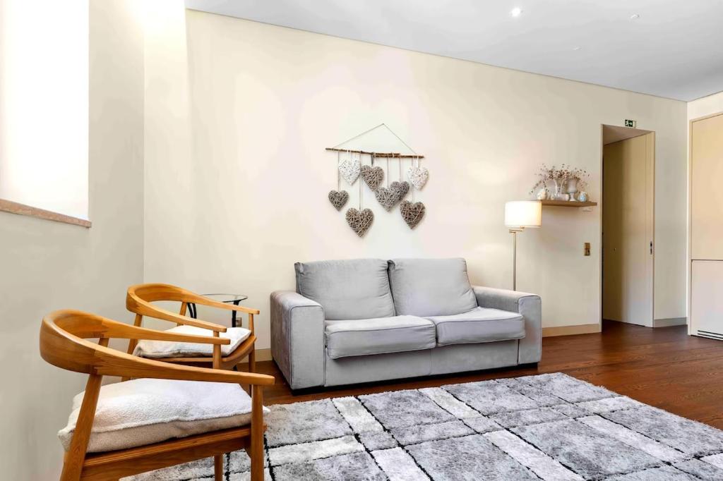a living room with a couch and a chair at The João I Collection Two Bedroom in Lisbon