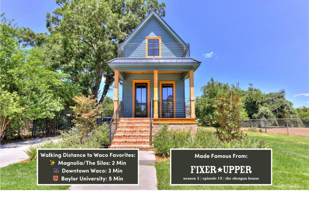 a small blue house with a sign in front of it at The Shotgun House from Fixer Upper - 800 5-Stars - Steps to Silos, BU, & Downtown in Waco