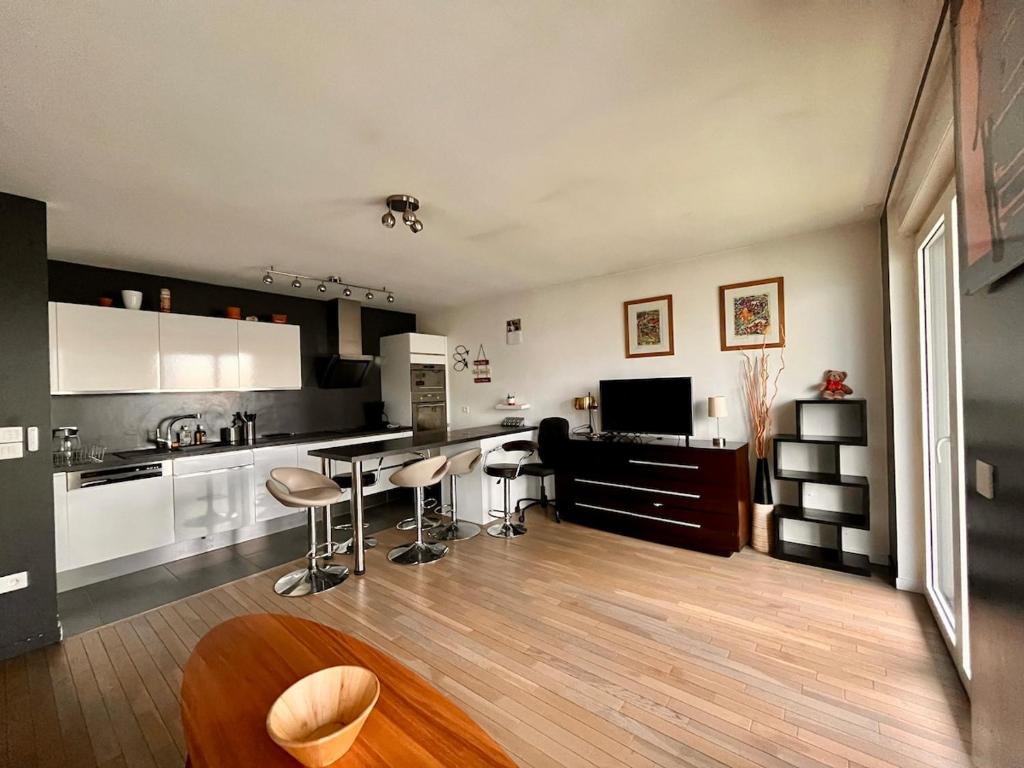 une cuisine avec un comptoir et des tabourets dans une pièce dans l'établissement La Défense Panoramic Terrace and Parking, à Courbevoie