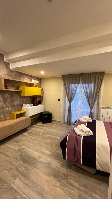 a bedroom with a bed and a large window at Belvedere Vallata Affitti brevi in Vallata