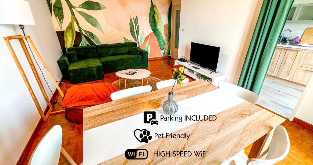 a living room with a table and a green couch at AC - Secure Parking - Near Central Station in Avignon