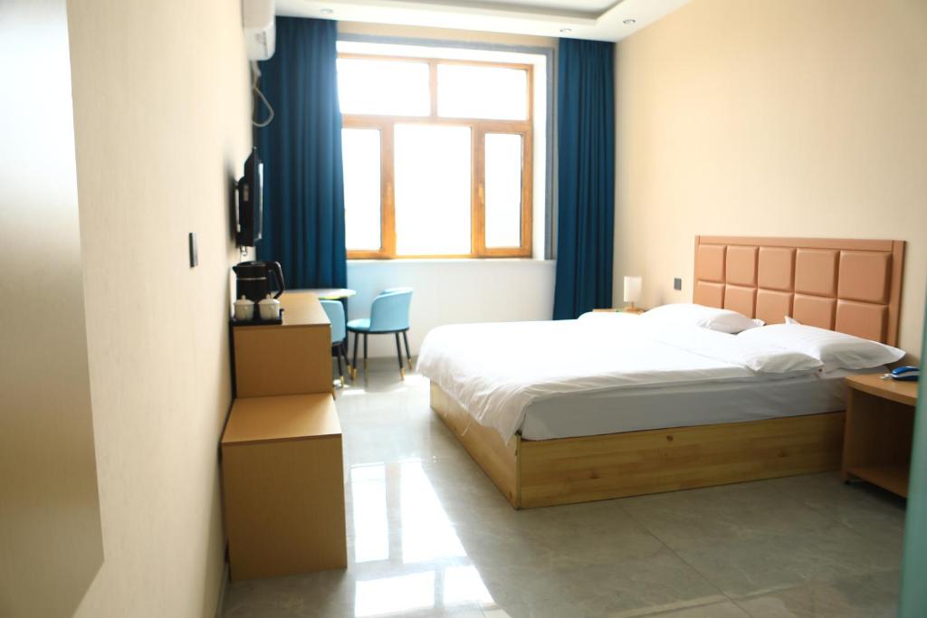 Postel nebo postele na pokoji v ubytování Hongge Hotel - Harbin Taiping Airport