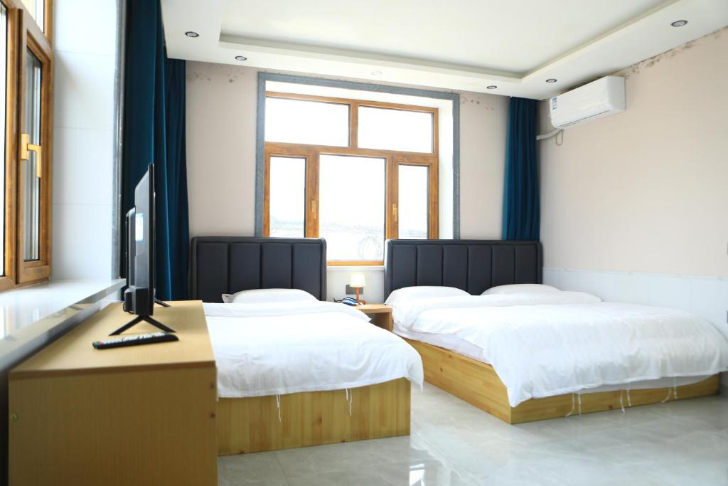 TV a/nebo společenská místnost v ubytování Hongge Hotel - Harbin Taiping Airport