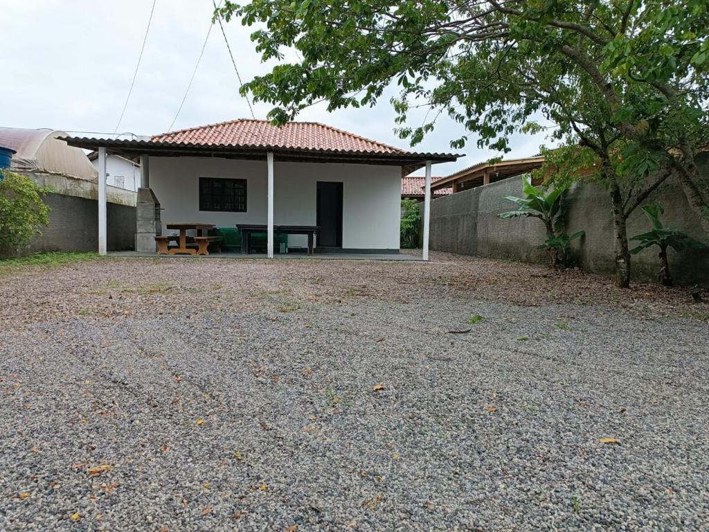 a small house with a table in front of it at Bela casa de praia in Palhoça