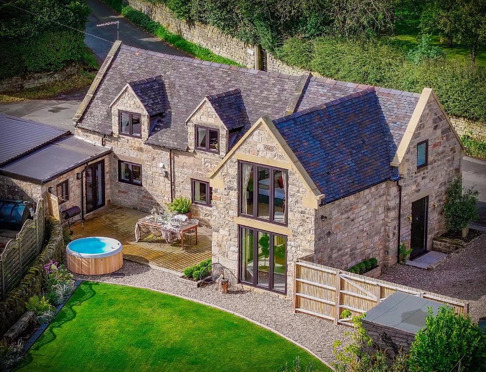 an aerial view of a large stone house with a backyard at Luxury Cottage in Peak District near Alton Towers in Stanton